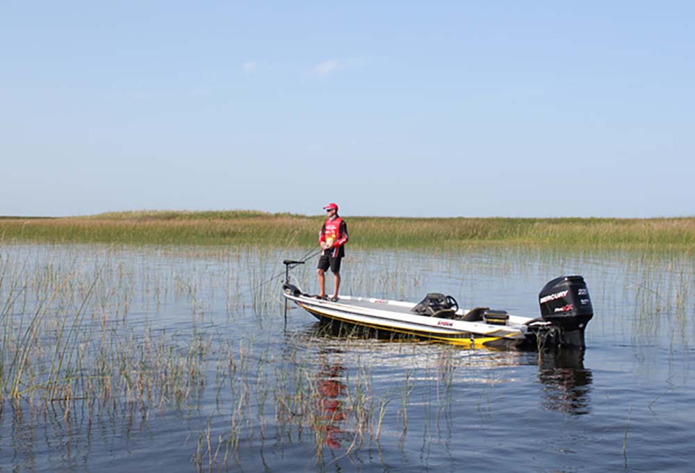 A panoramic view of Lake Okeechobee with a bass boat in the distance.